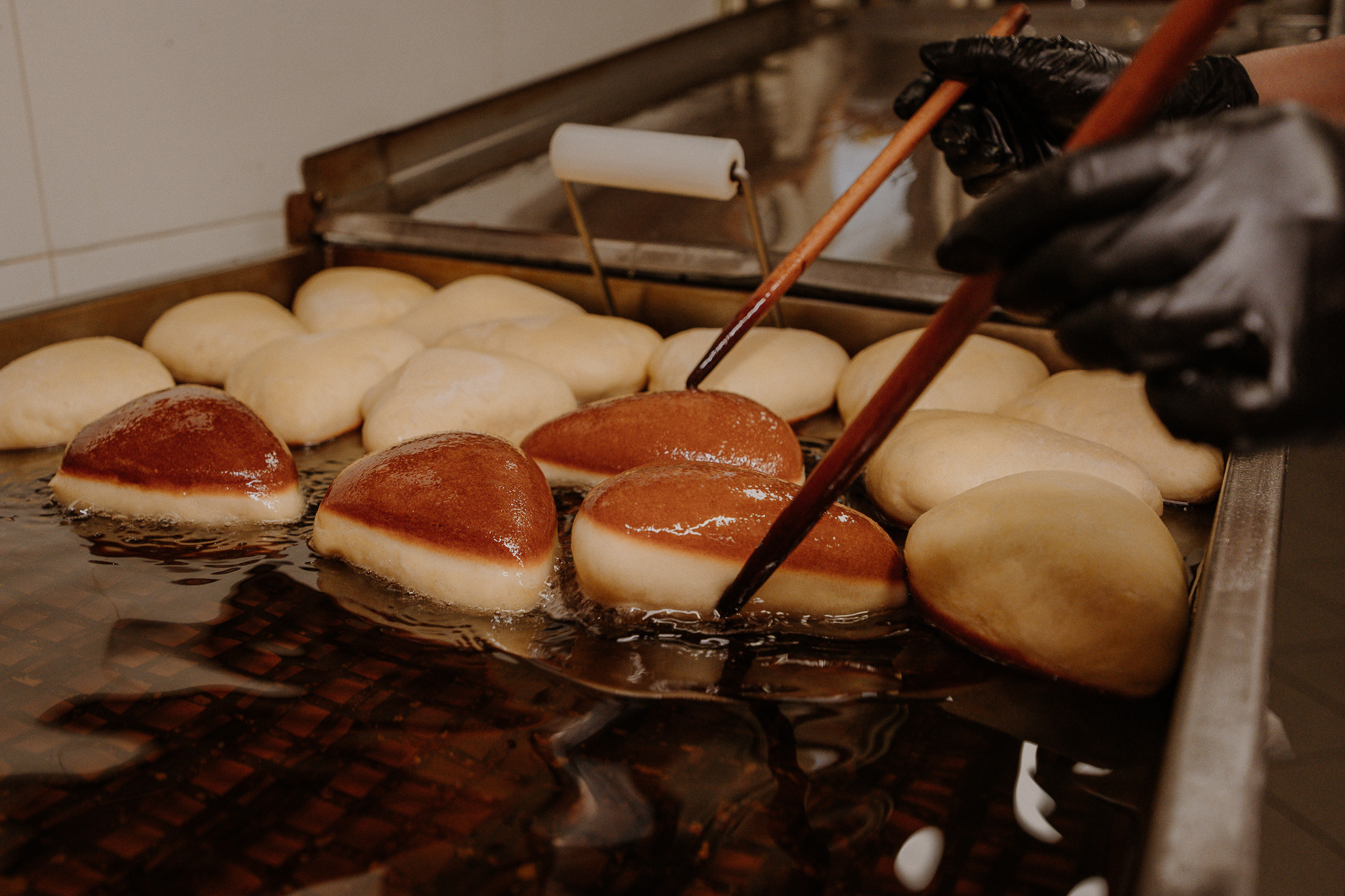 Frying doughnuts by hand